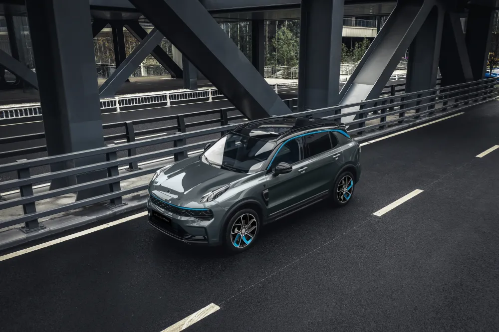 A Lynk & Co 01 PHEV driving on a multi-lane city bridge. This vehicle features distinctive blue accents and premium design.